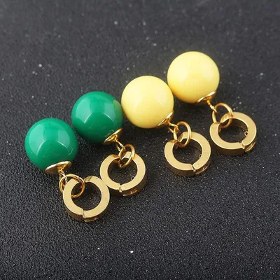Aretes Potara Dragon Ball verde y amarillo con cierres dorados